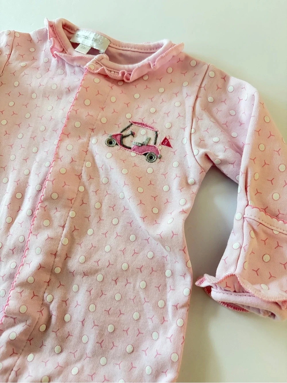 Magnolia baby pink footie with golf cart and golf ball print 3Mo